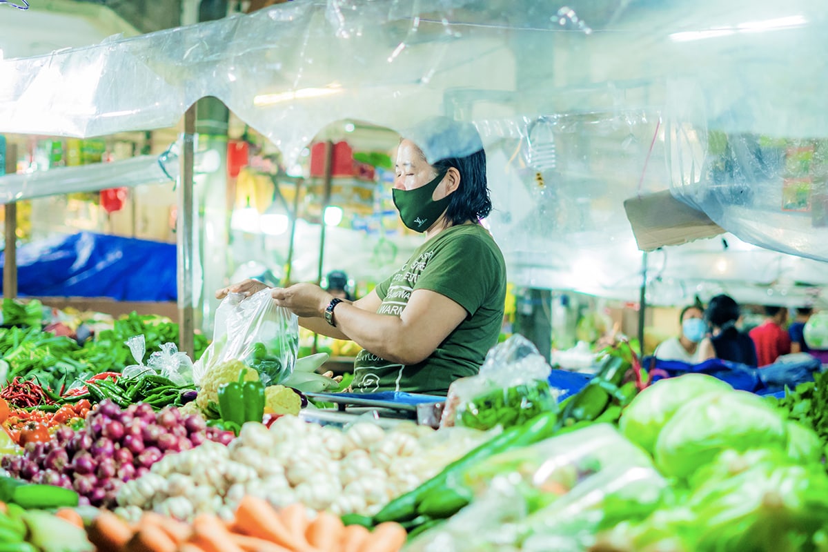 Indonesian woman selling fresh vegetables  in Badung Market, Denpasar
