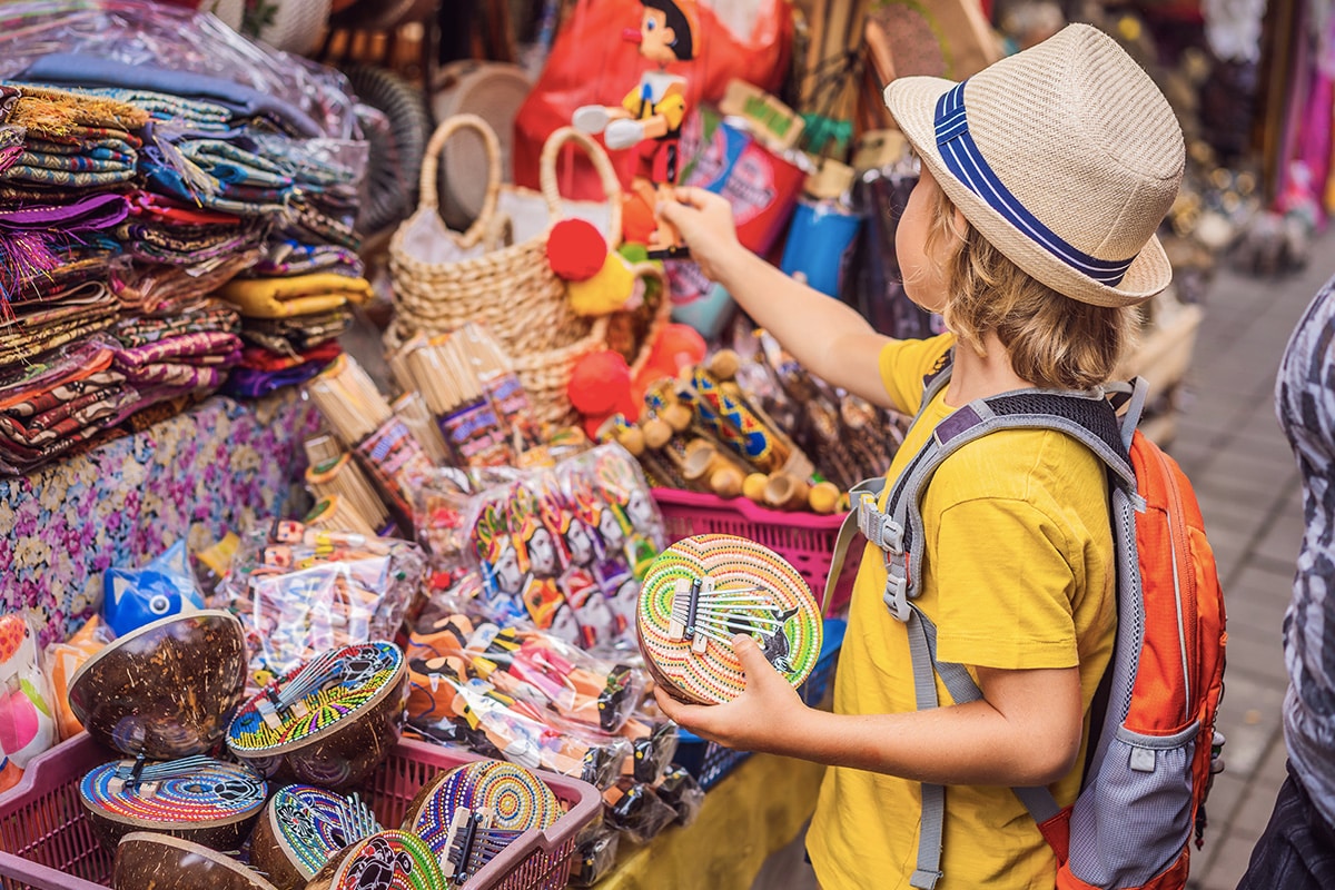 A boy buying Balinese knicks-knacks in the market