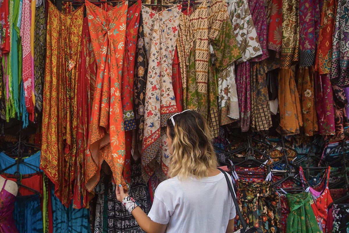 foreigner looking at vibrant art at Ubud Art Market Bali