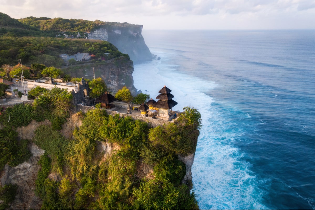 Uluwatu Temple above the cliff below the pristine water in bali